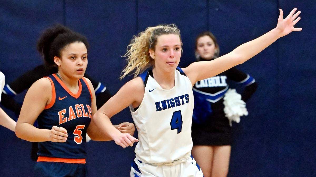 Lexington Catholic’s Katherine Truitt signals for a pass while guarded by Madison Southern’s Jada Carter during their first-round game of the 11th Region Tournament at Lexington Catholic on Monday night. Truitt scored a game-high 26 points in the win.