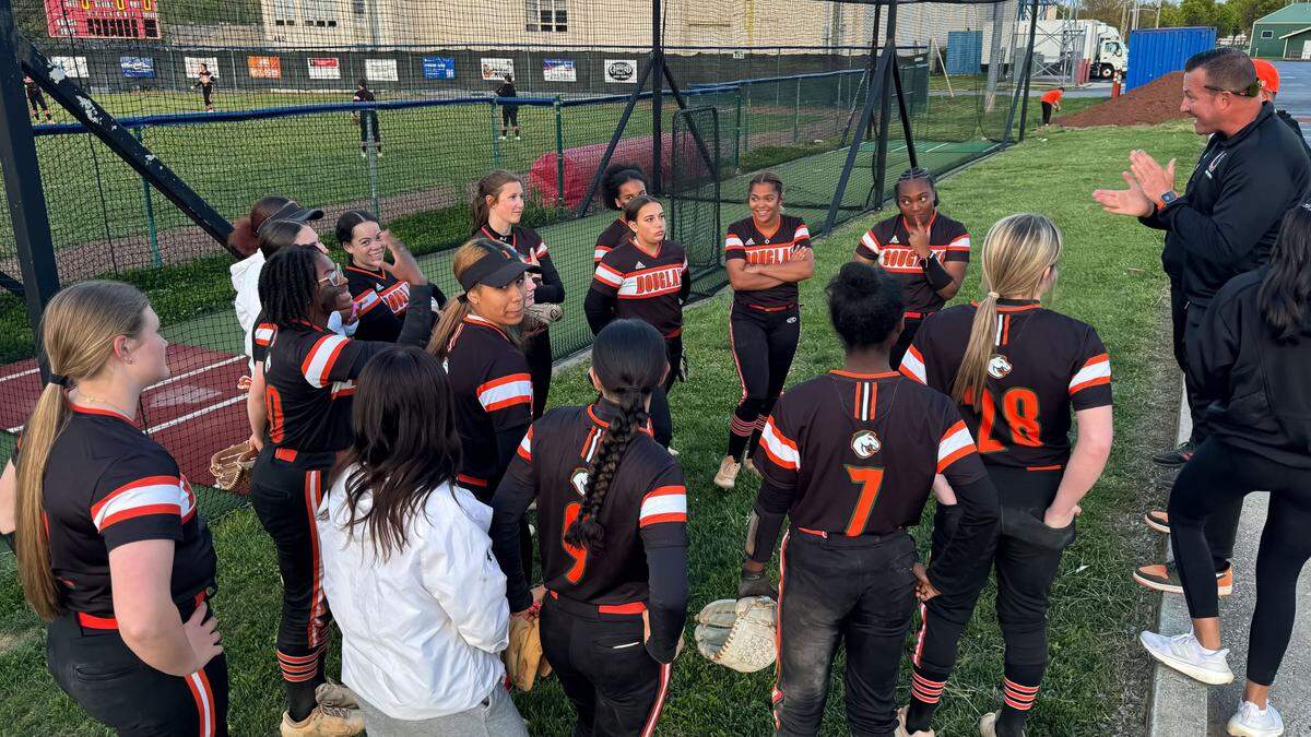 Frederick Douglass softball coach Jason McGuire, right, praised his team after the Broncos’ 13-7 win at Lafayette High School on Monday.