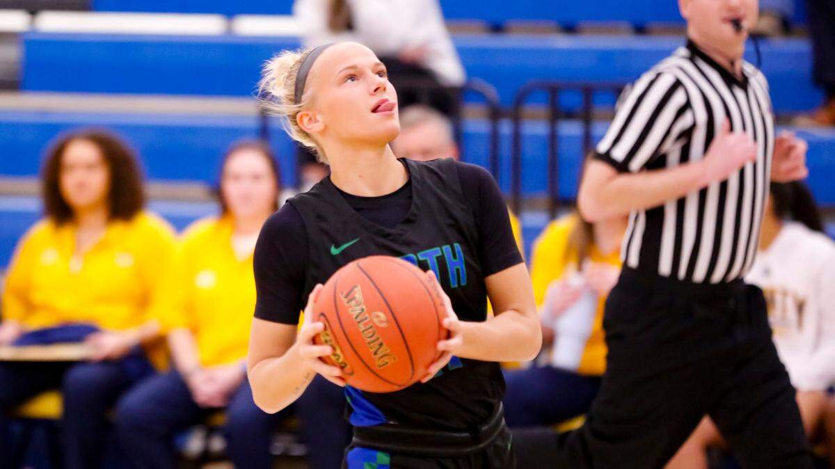 North Laurel’s Brooke Nichelson has a penchant for sticking her tongue out as she plays, especially as she picks up speed as she did on a fast-break layup during the first half of the Jaguars’ 63-57 win at Franklin County High School in Frankfort on Monday.