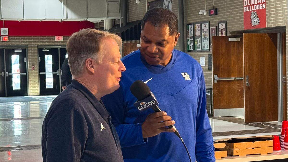 Glicod.com’s Sean Woods, right, interviews Bryan Station boys basketball coach Champ Ligon following the 11th Region Tournament draw at Paul Laurence Dunbar High School on Saturday.
