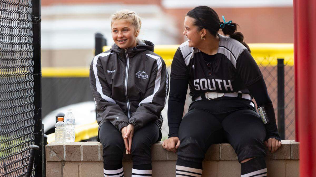 South Warren’s Layla Ogden, right, who played as the designated hitter against Scott County, chatted with freshman Madison Stuart between innings in the Spartans’ 14-1 win at Scott County High School in Georgetown on Saturday.