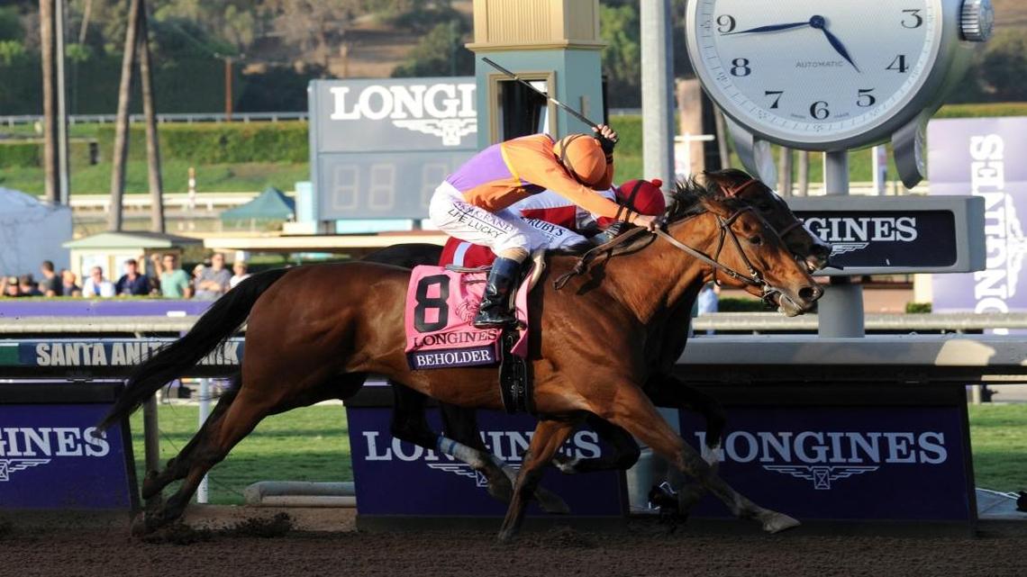 Jockey Gary Stevens, on Beholder, edges past Songbird to win the Longines Breeders' Cup Distaff, Friday, Nov. 4, 2016, at Santa Anita Park in Arcadia, Calif.