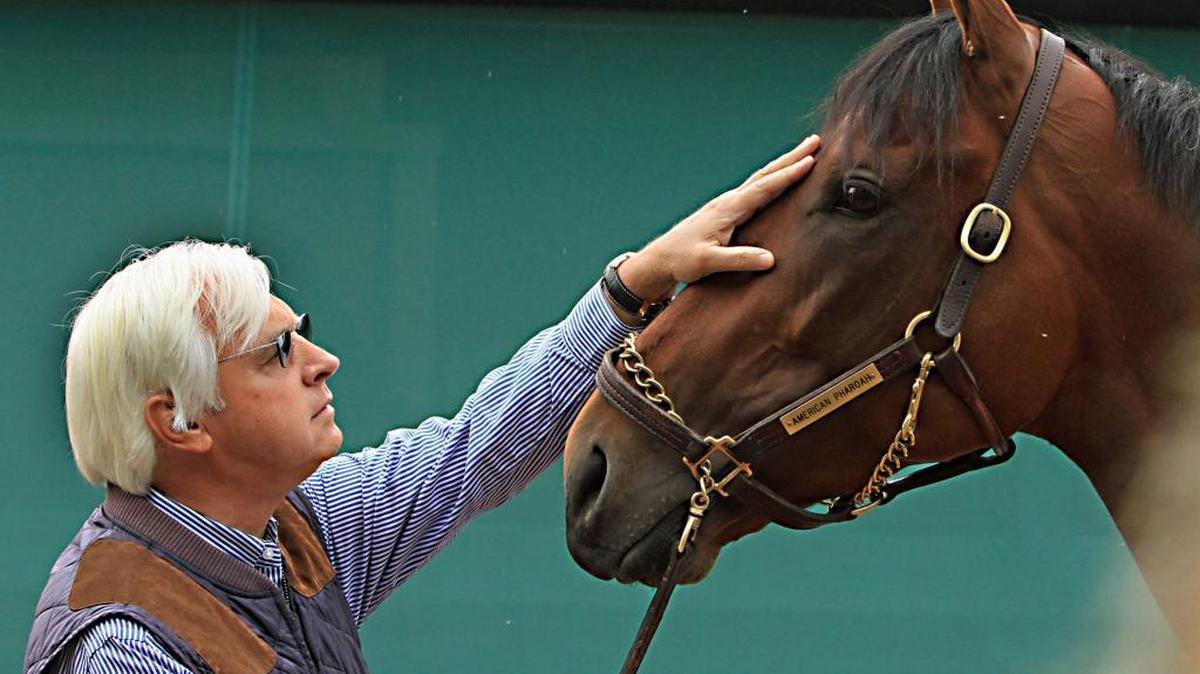 Trainer Bob Baffert rubs the head of American Pharoah outside the stakes barn at Pimlico Race Course in Baltimore. American Pharoah was named horse of the year at the Eclipse Awards on Saturday night, Jan. 16, 2016. The Triple Crown winner and Breeders' Cup Classic champion received all 261 votes for top honors at the Eclipse Awards, handed out at Gulfstream Park.