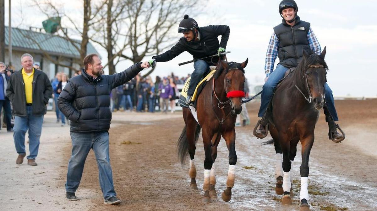 Nyquist trainer Doug O’Neill, left, fist-bumped Jonny Garcia after the Kentucky Derby favorite worked on the main track at Keeneland in April. Assistant trainer Jack Sisterson, right, led them back to the barn.