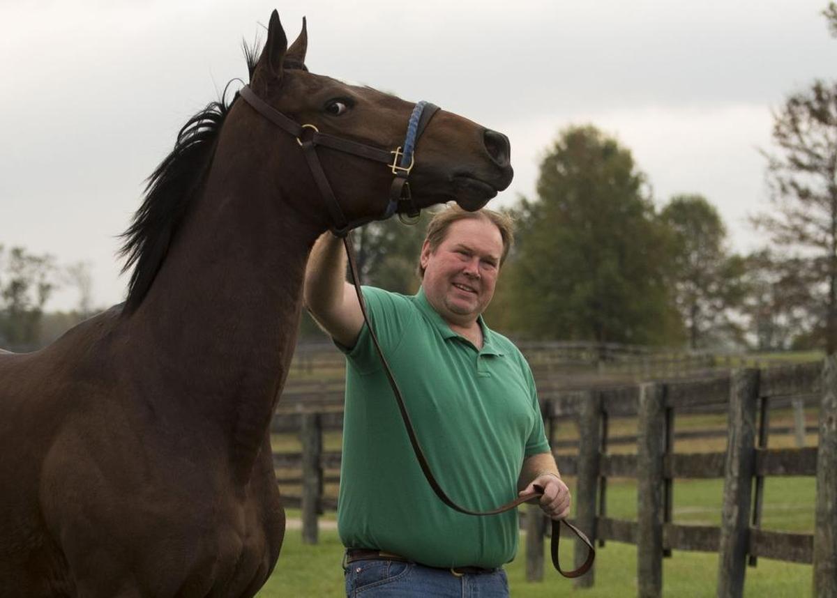 War Eagle’s Love won her first race ever at Keeneland last Friday. She was an inexpensive purchase, bought for $2,700 by Bryan Waldridge of Georgetown, who volunteers veterinary services at Old Friends Equine, a retirement home for Thoroughbreds. Waldridge, holding the filly, thinks he got her at a bargain price partly because she has a lot of white in one eye: a sign horsemen believe indicates a difficult temperament.