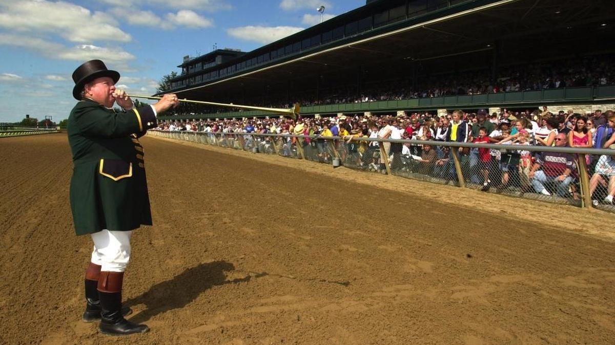 Keeneland track bugler Bucky Sallee plays the “call to the post” before the second race at Keeneland Race Course in Lexington KY. Saturday, October 5, 2002.