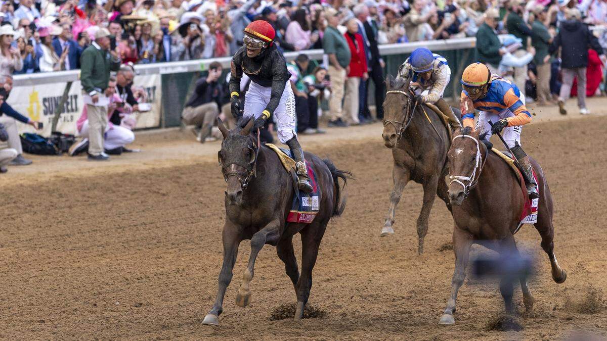 Jockey Jose Ortiz on Golden Tempo, left, celebrates after winning Kentucky Derby 152 on Saturday, May 2, 2026, at Churchill Downs in Louisville.