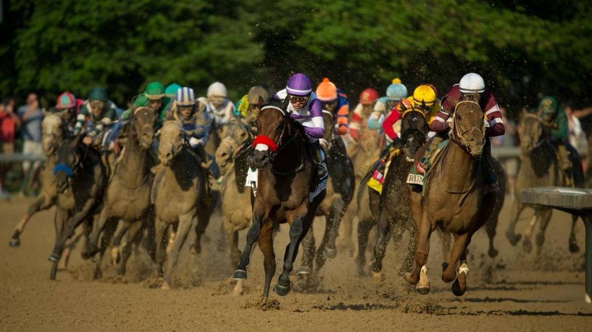 Nyquist with Mario Gutierrez up, center, rounds the final turn and moves on Gun Runner with Florent Geroux up to win the 142nd running of the Kentucky Derby, Saturday, May 07, 2016 at Churchill Downs in Louisville.