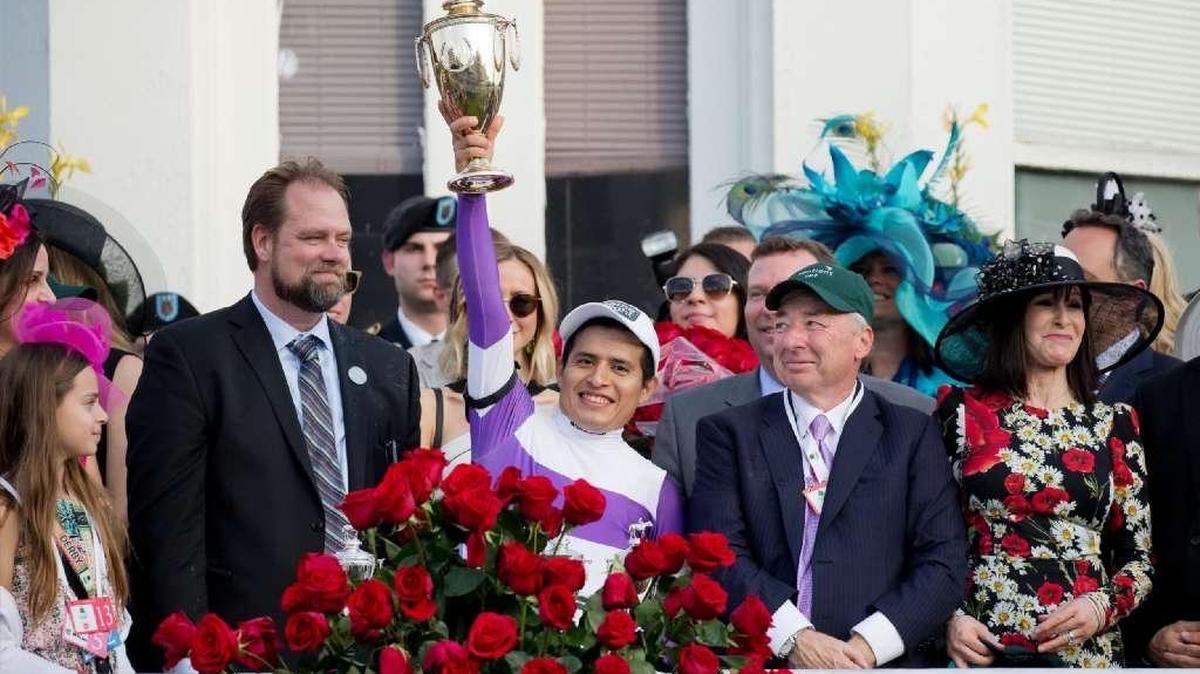 Jockey Mario Gutierrez held the trophy aloft after riding Nyquist to victory in the 142nd Kentucky Derby. Nyquist’s trainer Doug O’Neill, left, and owner J.Paul Reddam, right, looked on.