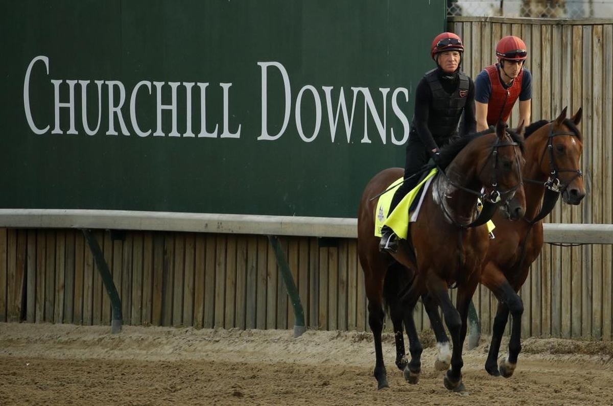 Kentucky Derby entrant Mendelssohn, left, trained along with an outrider at Churchill Downs in Louisville on Thursday.