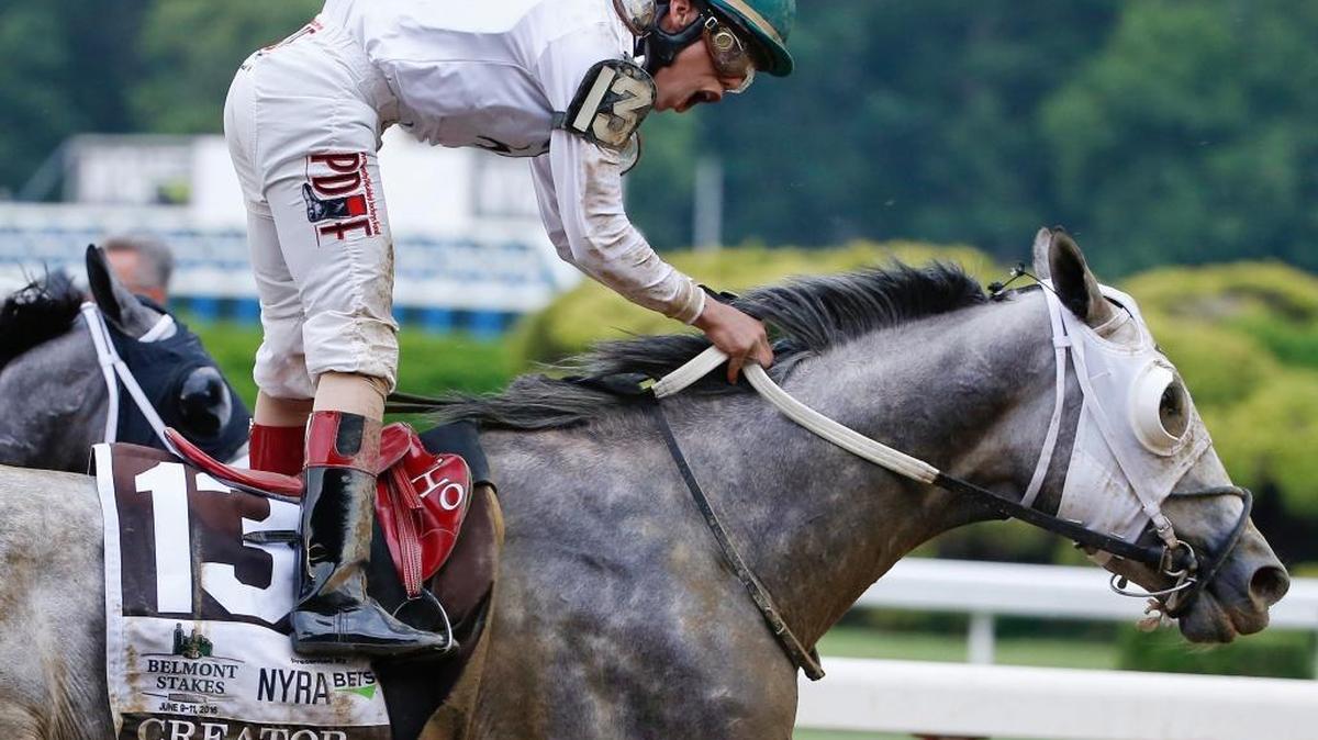 Jockey Irad Ortiz Jr., riding Creator, celebrates after winning the 148th running of the Belmont Stakes horse race, Saturday, June 11, 2016, in Elmont, N.Y. (AP Photo/Kathy Willens)