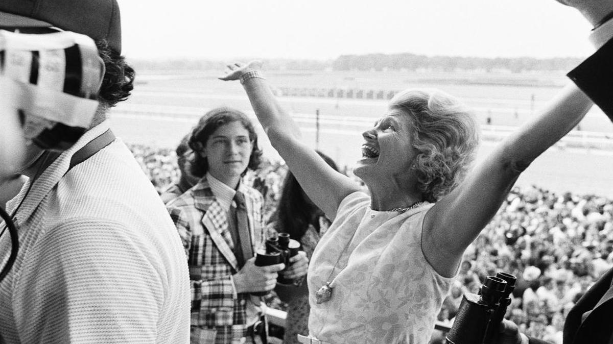 FILE - This June 9, 1973 file photo shows Penny Chenery, owner of Secretariat, reacting after her horse won the Belmont Stakes, and the Triple Crown, at Belmont Park in Elmont, N.Y. Kentucky Derby and Preakness Stakes winner California Chrome is at Belmont Park in Elmont, N.Y., preparing for the final leg of the Triple Crown. (AP Photo/Jack Kanthal, File)