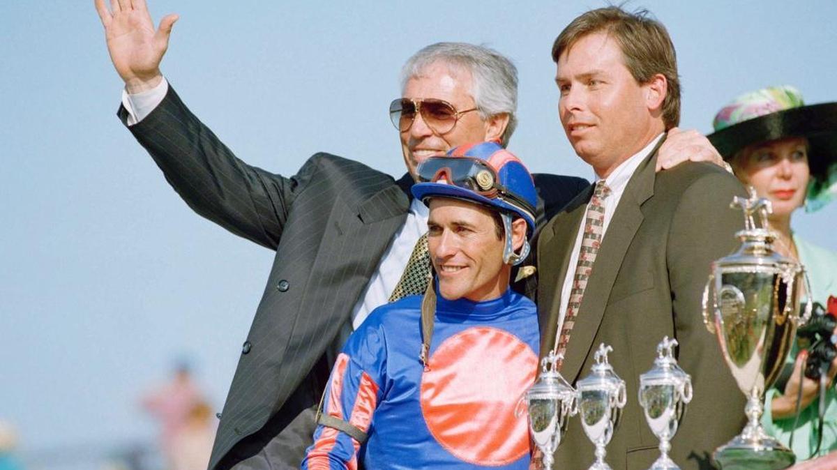 Trainer D. Wayne Lukas, left, jockey Gary Stevens, and assistant trainer Jeff Lukas, right, celebrate in the winners circle after Thunder Gulch won the 121st running of the Kentucky Derby, at Churchill Downs on Saturday, May 6, 1995, in Louisville, Ky. Jeff Lukas is the son of Wayne Lukas.