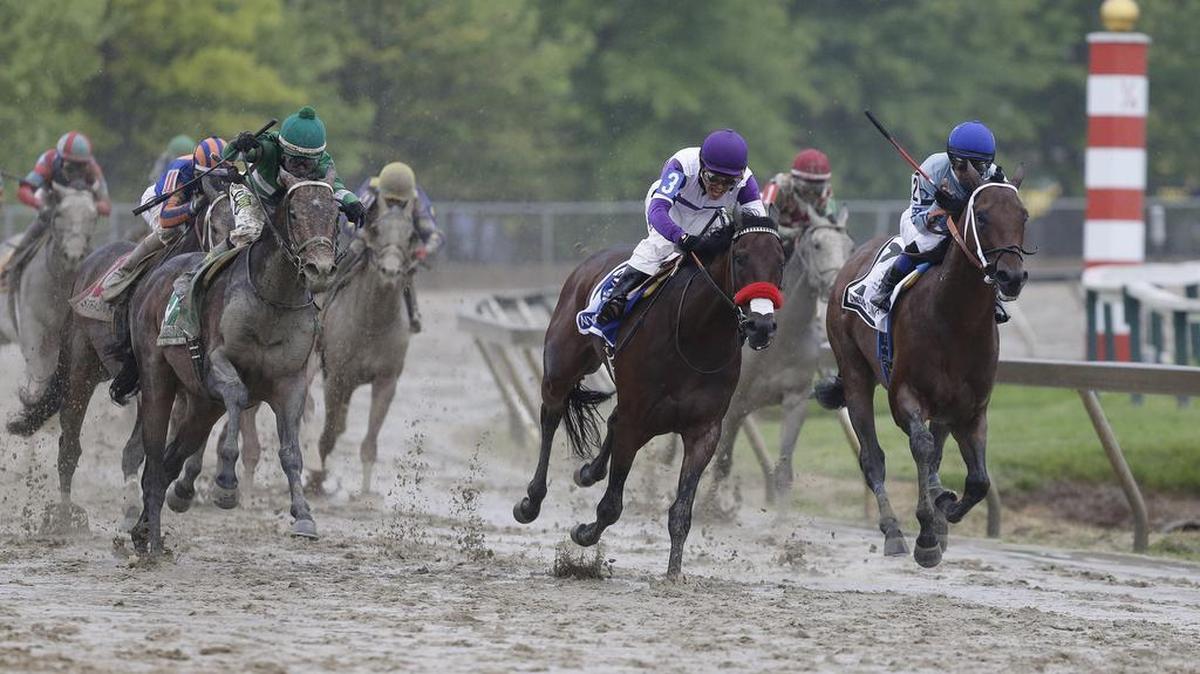 Exaggerator, left, with Kent Desormeaux aboard moves up on Nyquist (3) with Mario Gutierrez aboard during the 141st Preakness Stakes horse race at Pimlico Race Course, Saturday, May 21, 2016, in Baltimore. Exaggerator won the race. (AP Photo/Garry Jones)