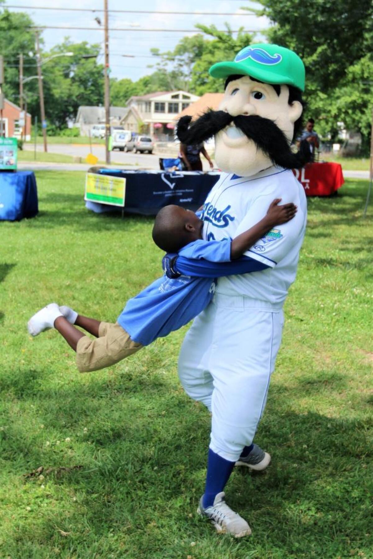 Braydon Brown, age 6, of Lexington, received a hug and a twirl from the Lexington Legends mascot “Big L,” at the 13th Annual Father’s Day Family Celebration at Douglass Park on Saturday, June 17, 2017.
