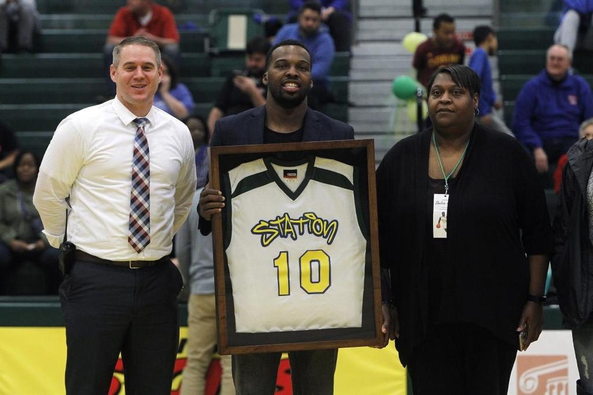 Shelvin Mack posed with Bryan Station Principal James McMillin and Mack’s mother, Victoria, when Bryan Station retired Mack’s high school jersey last February.
