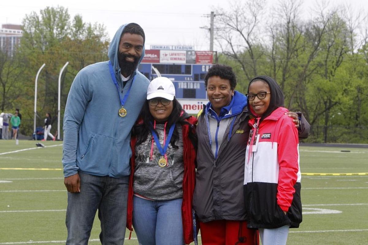 Lafayette track coach Crystal Washington presented commemorative medals to Tyson Gay, left, and Shoshana Boyd, parents of Trinity Gay, who were joined by Trinity’s cousin Chelsea Cloyd at the Tyson and Trinity Gay Memorial track meet at Ishmael Stadium in Lexington in April.