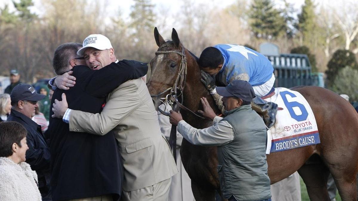 Robert Anderson and co-owner Jason Loutsch hugged as jockey Luis Saez kissed Brody’s Cause after wining the Grade I Toyota Blue Grass Stakes at Keeneland Race Course in Lexington on Saturday.