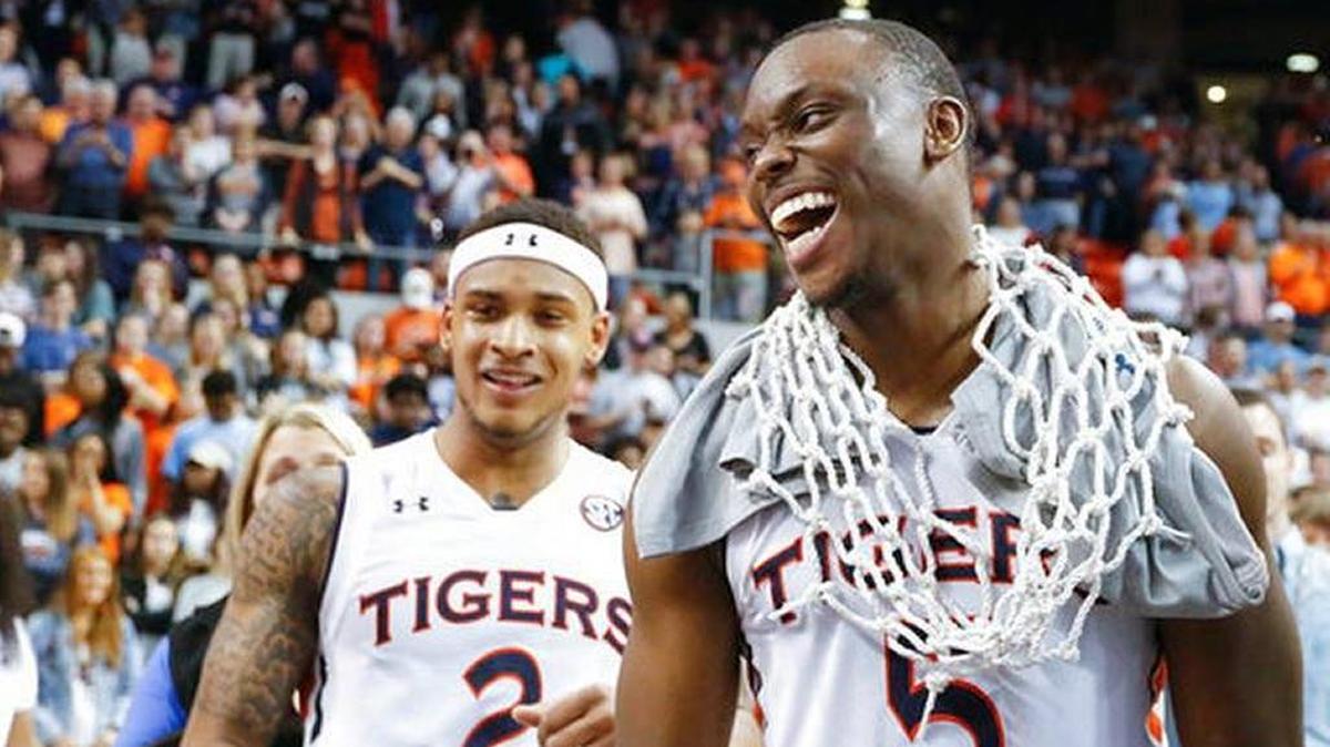 Auburn guard Mustapha Heron (5) wore a basketball net after the Tigers defeated South Carolina to earn a share of the SEC title last Saturday at Auburn, Ala. Auburn opens SEC Tournament play on Friday in St. Louis.