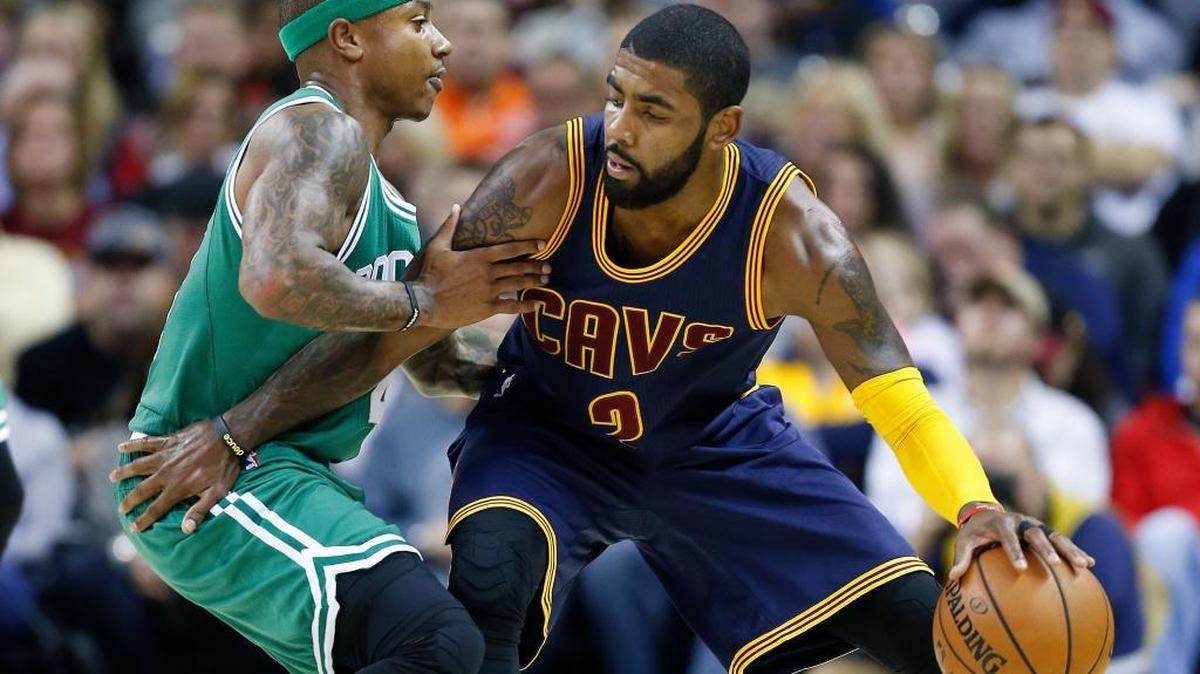 In this Nov. 3, 2016, file photo, Cleveland Cavaliers guard Kyrie Irving, right, looks to drive against Boston Celtics guard Isaiah Thomas during the first half of an NBA basketball game in Cleveland. The two switched teams this week in a blockbuster trade on Tuesday, August 22, 2017.