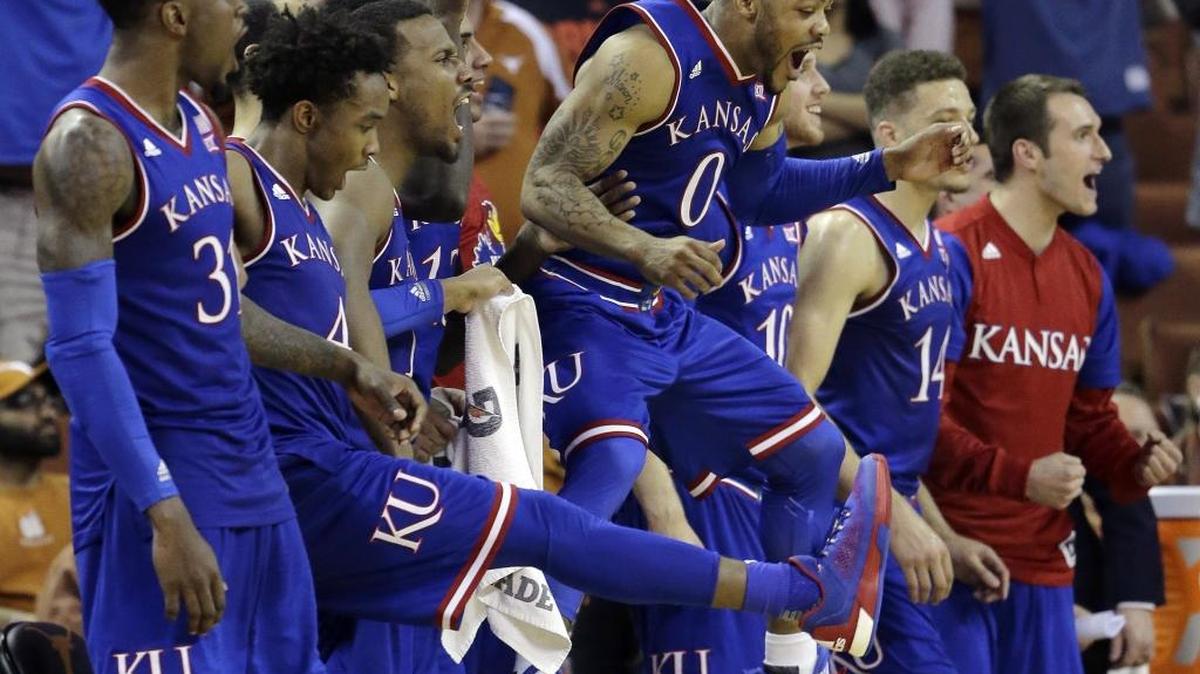 Kansas guard Frank Mason III (0) leaps in the air as he and teammates celebrate a score against Texas during the second half of an NCAA college basketball game, Monday, Feb. 29, 2016, in Austin, Texas. Kansas won 86-56.
