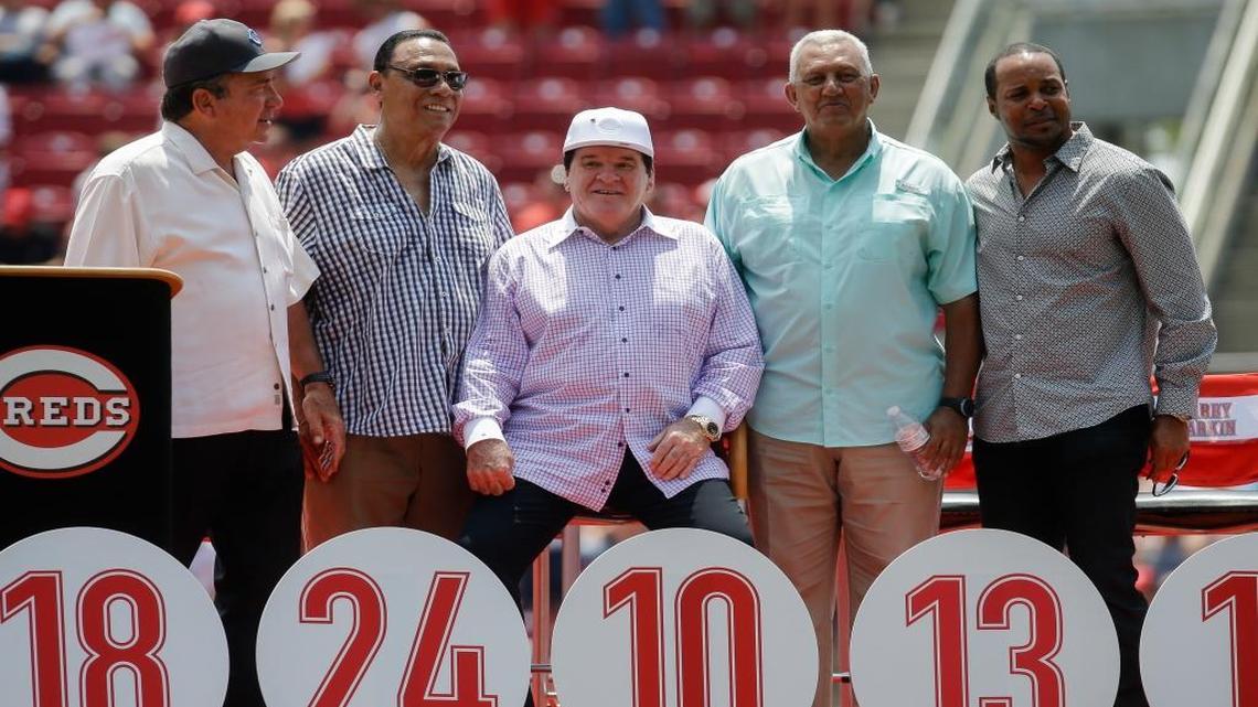 Former Cincinnati Reds player Pete Rose, center, sits with Reds greats, from left to right, Johnny Bench, Tony Perez, Dave Concepcion and Barry Larkin during a ceremony to retire his No. 14 before a baseball game against the San Diego Padres, Sunday, June 26, 2016, in Cincinnati.