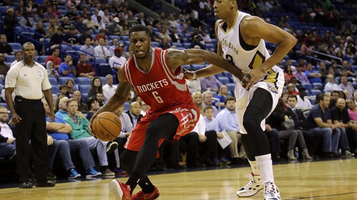 Former UK forward Terrence Jones drives around his former UK teammate Anthony Davis in an NBA game last season. Jones was not offered a contract by the Houston Rockets.