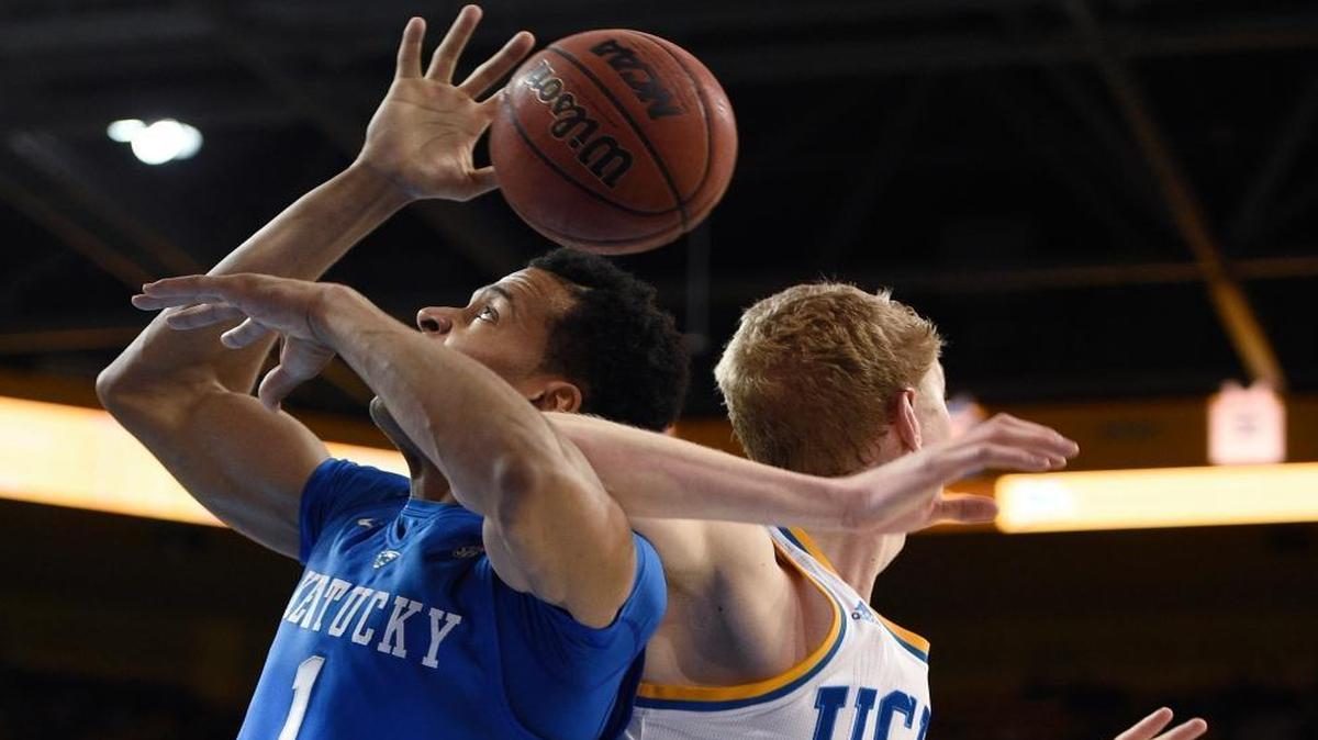 Kentucky forward Skal Labissiere, left, and UCLA center Thomas Welsh look for a rebound during the first half of an NCAA college basketball game in Los Angeles, Thursday, Dec. 3, 2015.