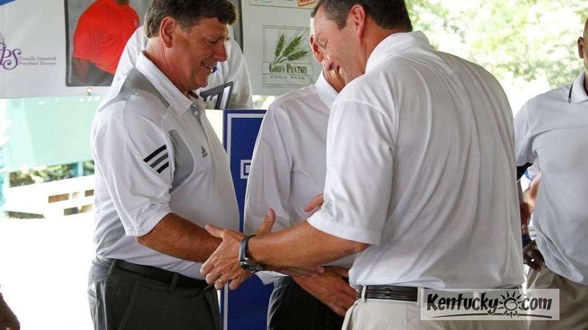 University of Kentucky Athletics Director Mitch Barnhart, right, greeted University of Louisville Athletics Director Tom Jurich on July 25 at the annual luncheon to promote the annual Governor’s Cup football game. This year’s game between the Cats and the Cards is Saturday.