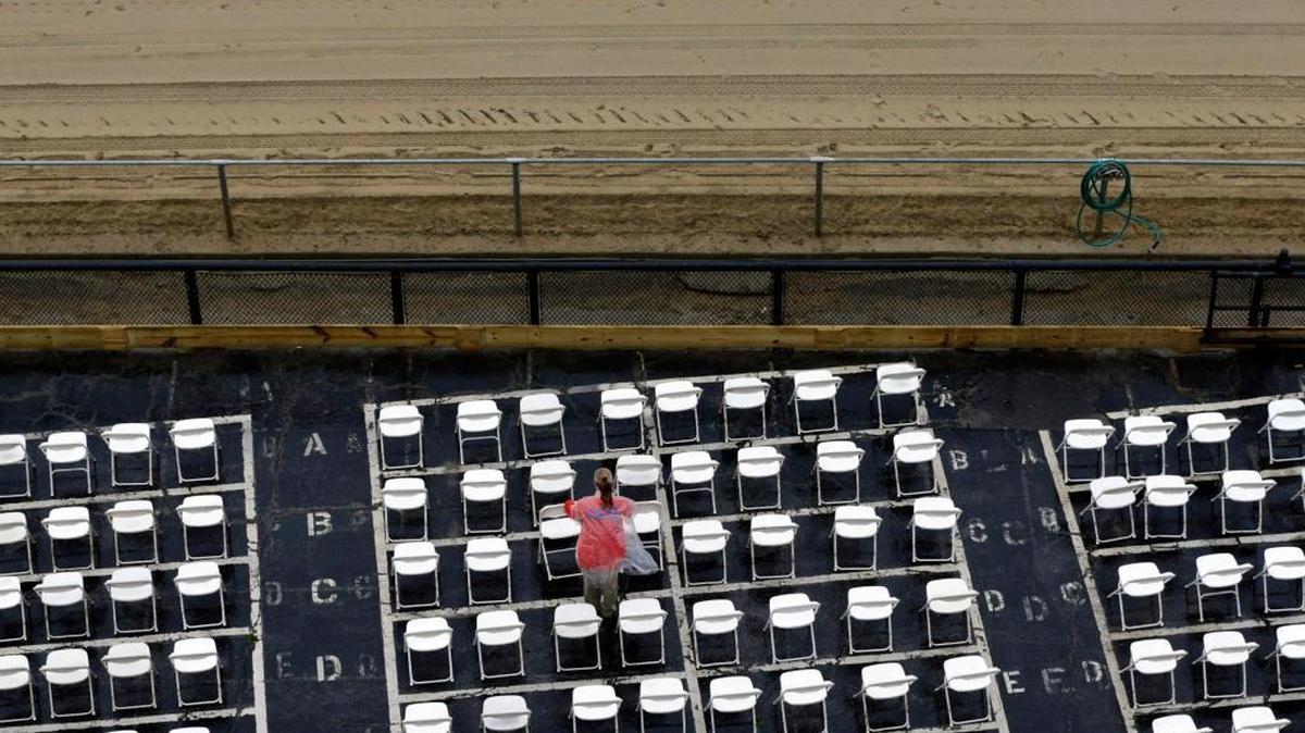 An usher cleared water off of trackside seats as rain fell before the 141st running of the Preakness Stakes on Saturday. Exaggerator defeated Kentucky Derby winner Nyquist to end any thoughts of a second Triple Crown winner in as many years.