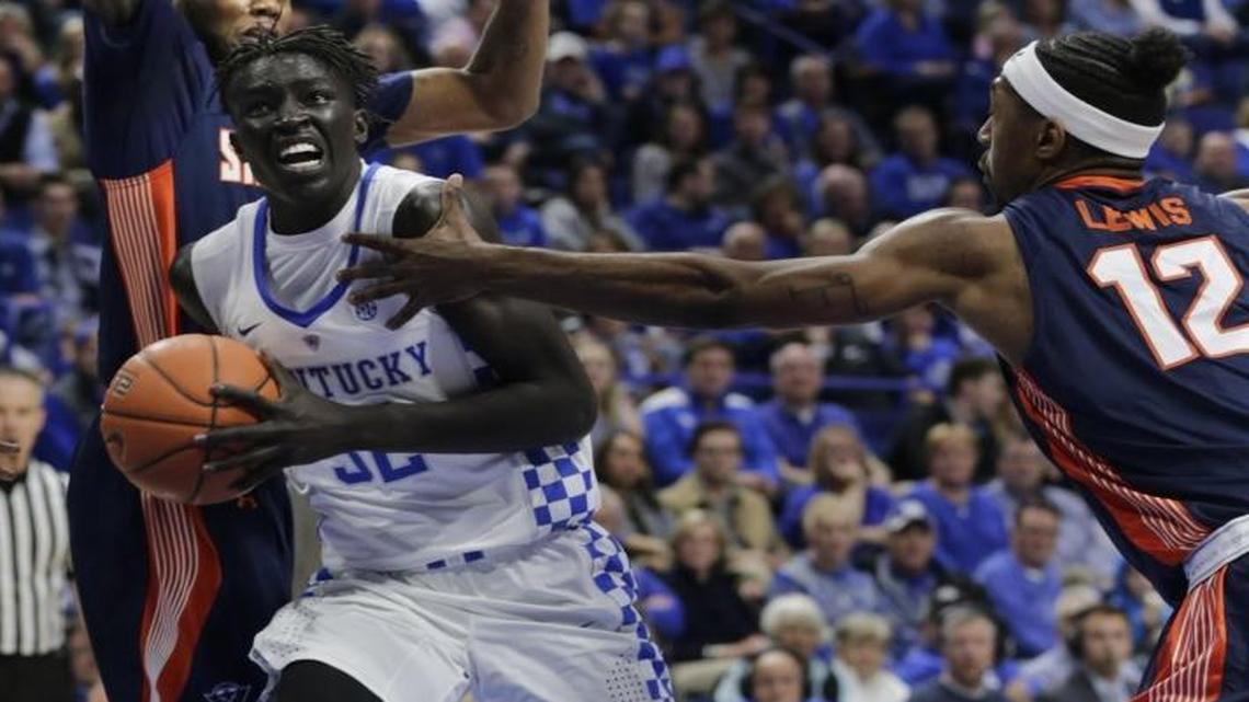 Kentucky’s Wenyen Gabriel got between Tennessee-Martin’s Kedar Edwards, left, and Tennessee-Martin’s Fatodd Lewis (12) to score in the first half of UK’s win at Rupp Arena on Nov. 25. Gabriel has been splitting time and starts with senior Derek Willis.
