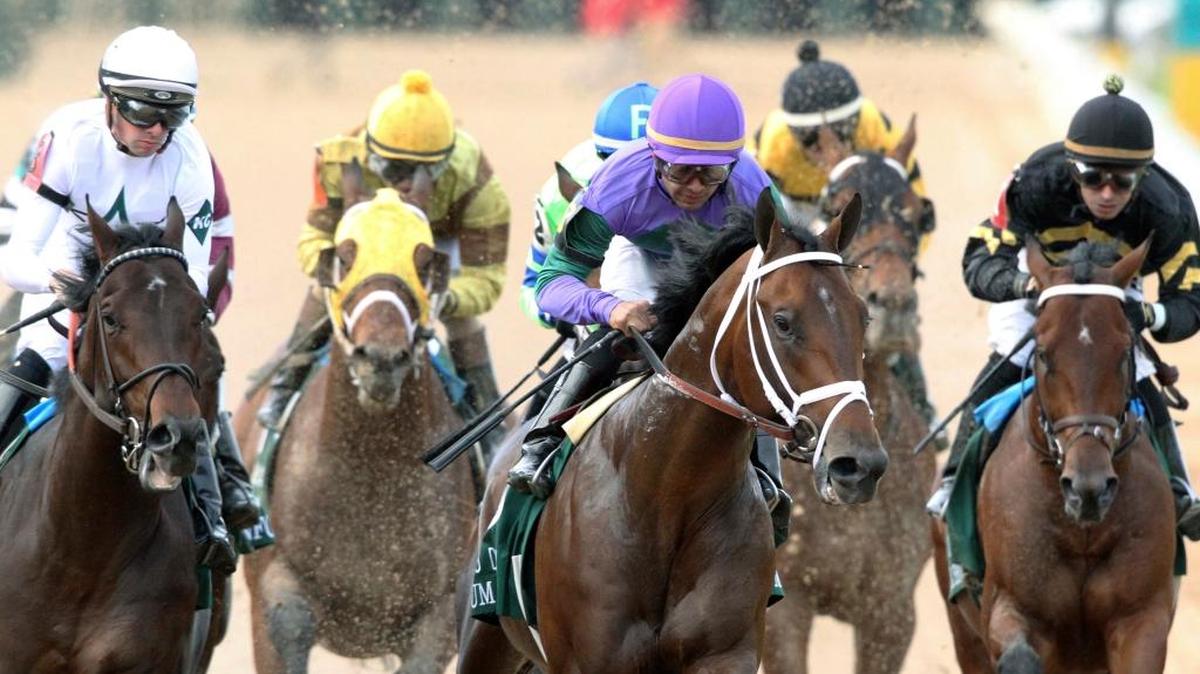Magnum Moon, center, with jockey Luis Saez aboard, led on the way to winning the Arkansas Derby on Saturday at Oaklawn Park in Hot Springs, Ark.