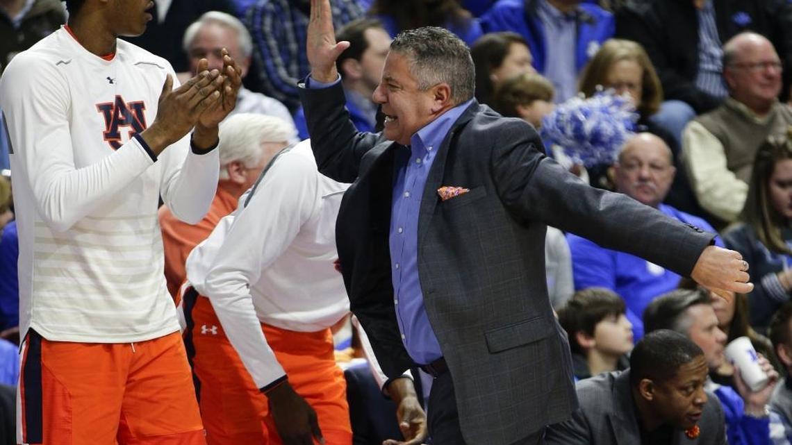 Auburn head coach Bruce Pearl high-fived his bench after a three-pointer banked in for his team during its 92-72 loss to Kentucky last January in Lexington. One of Pearl’s assistant coaches, Chuck Person, was charged in September in a federal investigation into college basketball recruiting.