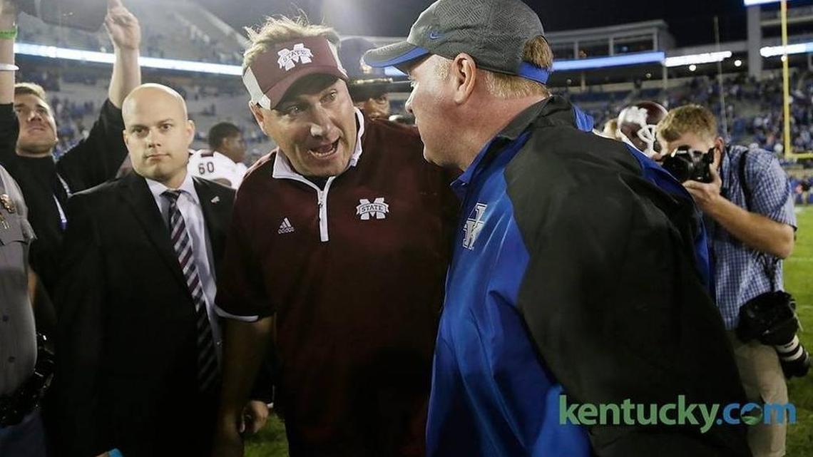 Mississippi State coach Dan Mullen and Kentucky coach Mark Stoops talk after Mullen’s No. 1 ranked Bulldogs beat Kentucky 45-31 in 2014.