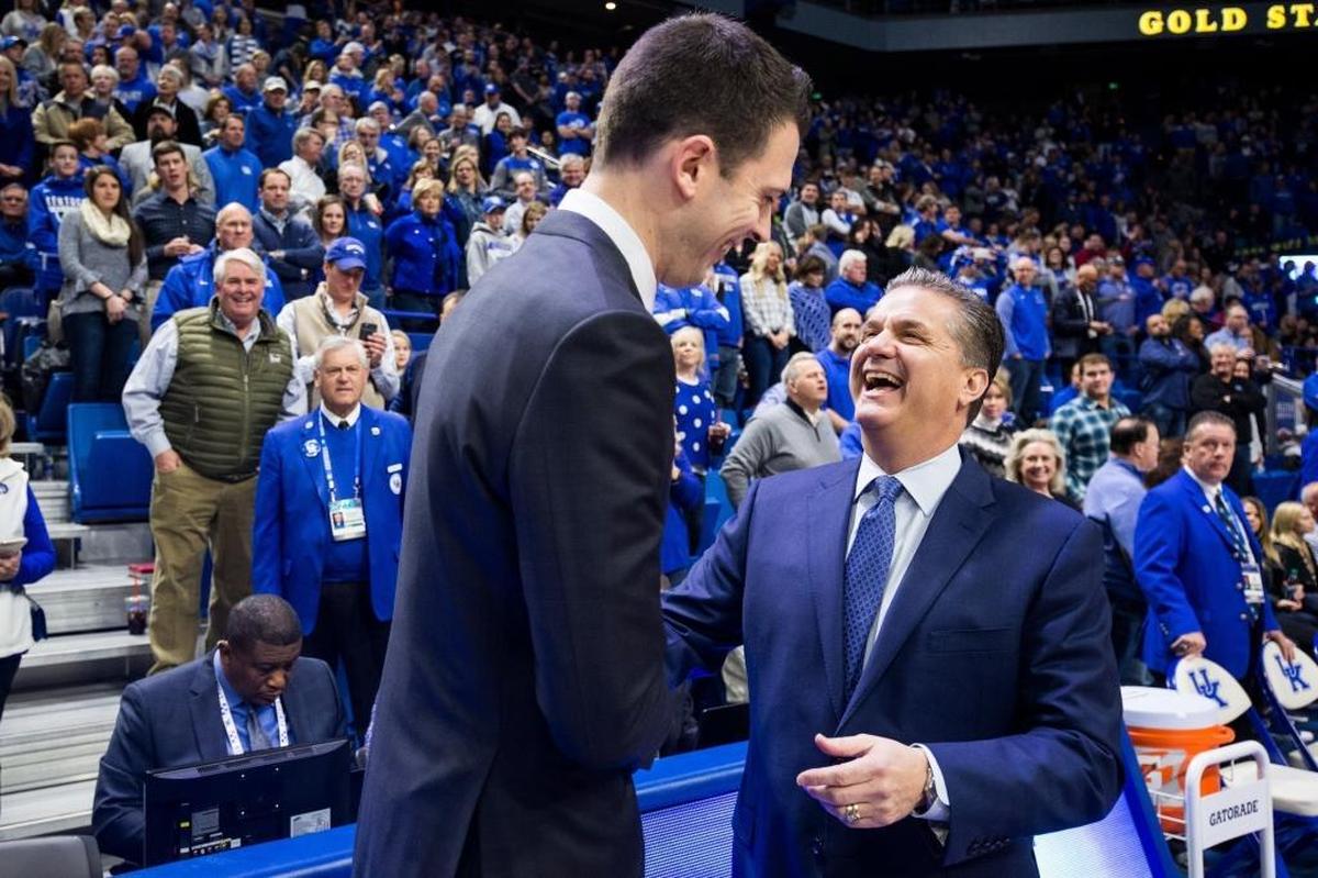 Kentucky head coach John Calipari, right, shook hands with then-Louisville interim head coach David Padgett before UK’s 90-61 beat down of the Cardinals in Rupp Arena last year. Calipari is 9-2 against U of L as Wildcats head man.
