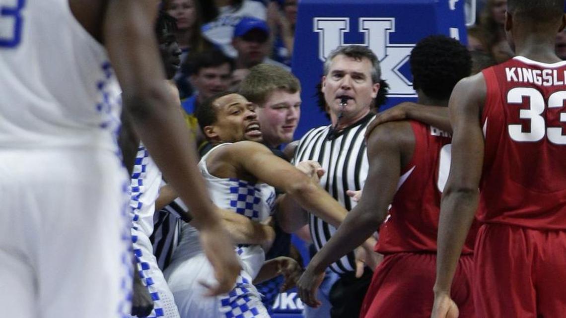 Kentucky guard Isaiah Briscoe (13) wasn’t happy after getting stepped on by guard Jaylen Barford (0) as host Kentucky defeated Arkansas 97-71. Official Doug Shows tried to keep the peace.