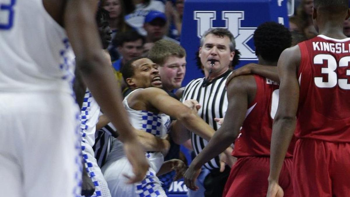 Kentucky guard Isaiah Briscoe (13) wasn’t happy after getting stepped on by guard Jaylen Barford (0) as host Kentucky defeated Arkansas 97-71. Official Doug Shows tried to keep the peace.