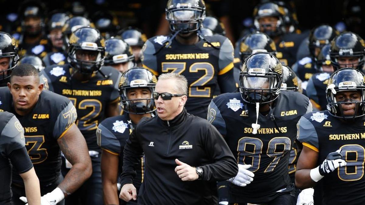 Southern Mississippi coach Todd Monken and his team arrive on the field for the Heart of Dallas Bowl NCAA college football game against Washington, Saturday, Dec. 26, 2015, in Dallas. Washington won 44-31.