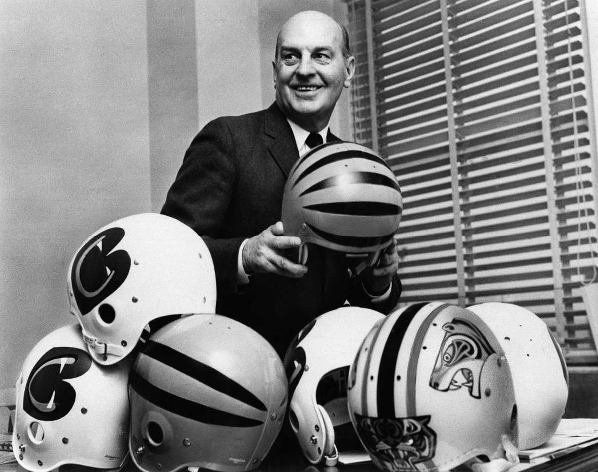 Paul Brown, President of the New Cincinnati Bengals of the American Football League, is trying to select the design, helmets, Jan. 3, 1968 in Cincinnati, to be worn by his team when it starts play in the A.F.L. next fall. Brown hasn?t made up his mind yet, which helmet it will be. (AP Photo)