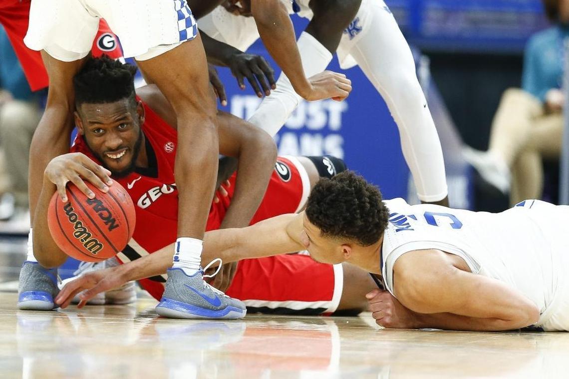 Georgia forward Yante Maten (1) and Kentucky forward Kevin Knox (5) battled for the ball during the SEC Tournament quarterfinals Friday at the Scottrade Center. Kentucky beat Georgia 62-49 to advance to a Saturday semifinal game against Alabama.