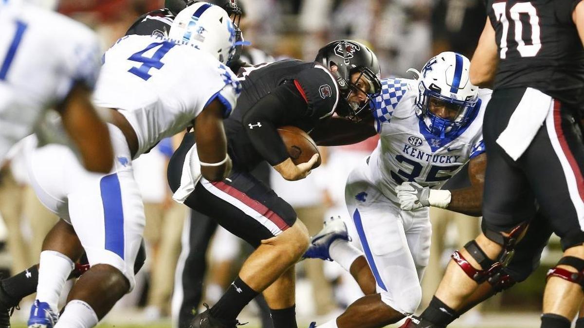 Kentucky linebacker Joshua Paschal (4) and defensive end Denzil Ware (35) stop South Carolina Gamecocks quarterback Jake Bentley (19) during UK’s win over the Gamecocks at William Brice Stadium in Columbia, S.C., Saturday, Sept 16, 2017. Ware has announced he will return for his senior season.