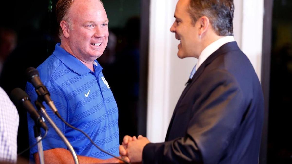 UK head football coach Mark Stoops talked to Kentucky Gov. Matt Bevin, right, at the Governor's Cup luncheon at Frankfort Country Club on Tuesday during the Governor’s Cup Luncheon.