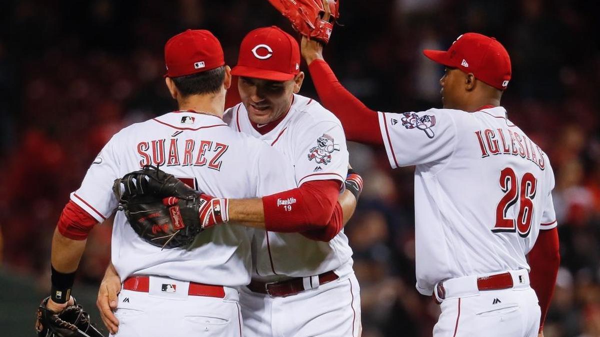 Cincinnati Reds first baseman Joey Votto, center, celebrates with third baseman Eugenio Suarez, left, and relief pitcher Raisel Iglesias (26) after the Reds defeated the New York Yankees 5-3 on Tuesday, May 9, 2017, in Cincinnati.
