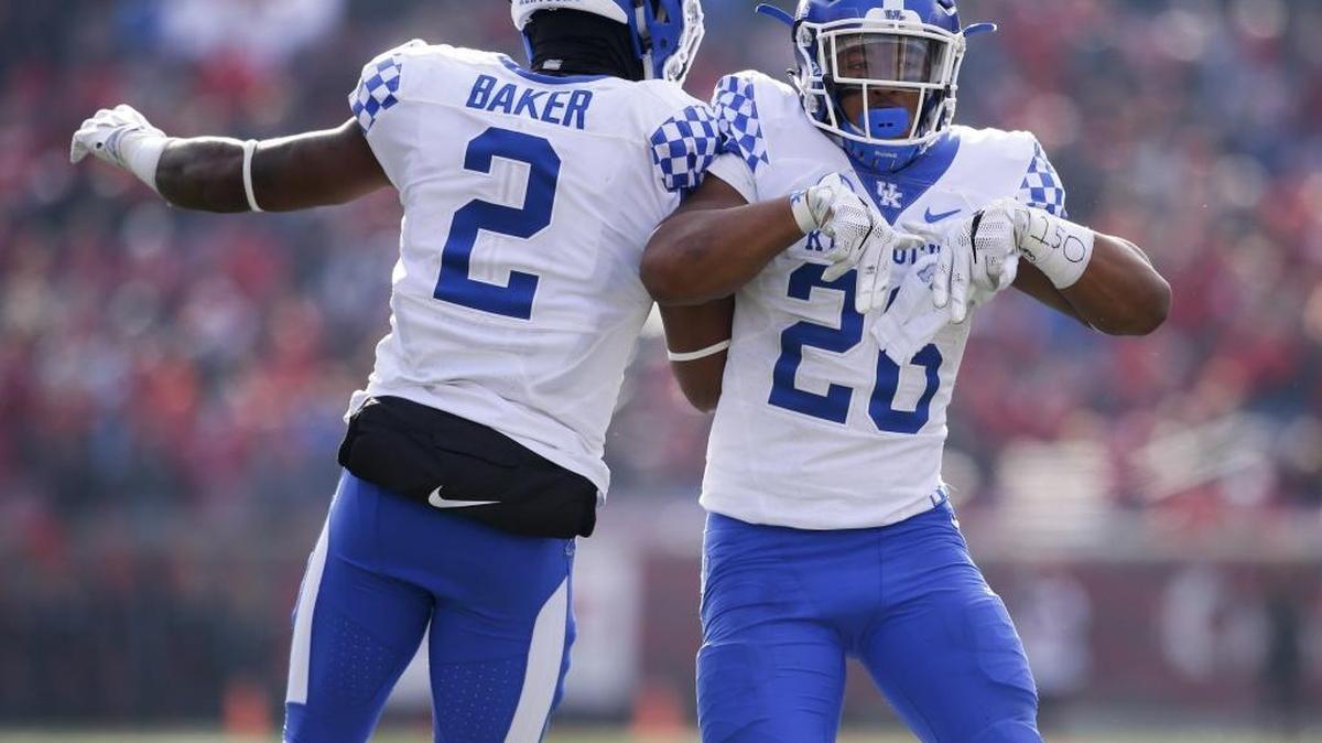 Kentucky running back Benny Snell Jr. (26) celebrated his third-quarter touchdown with wide receiver Dorian Baker (2) as Kentucky defeated Louisville 41-38 on Saturday November 26, 2016 in Louisville, Ky. Both Snell and Baker are expected to be key members of the UK offense in 2017.