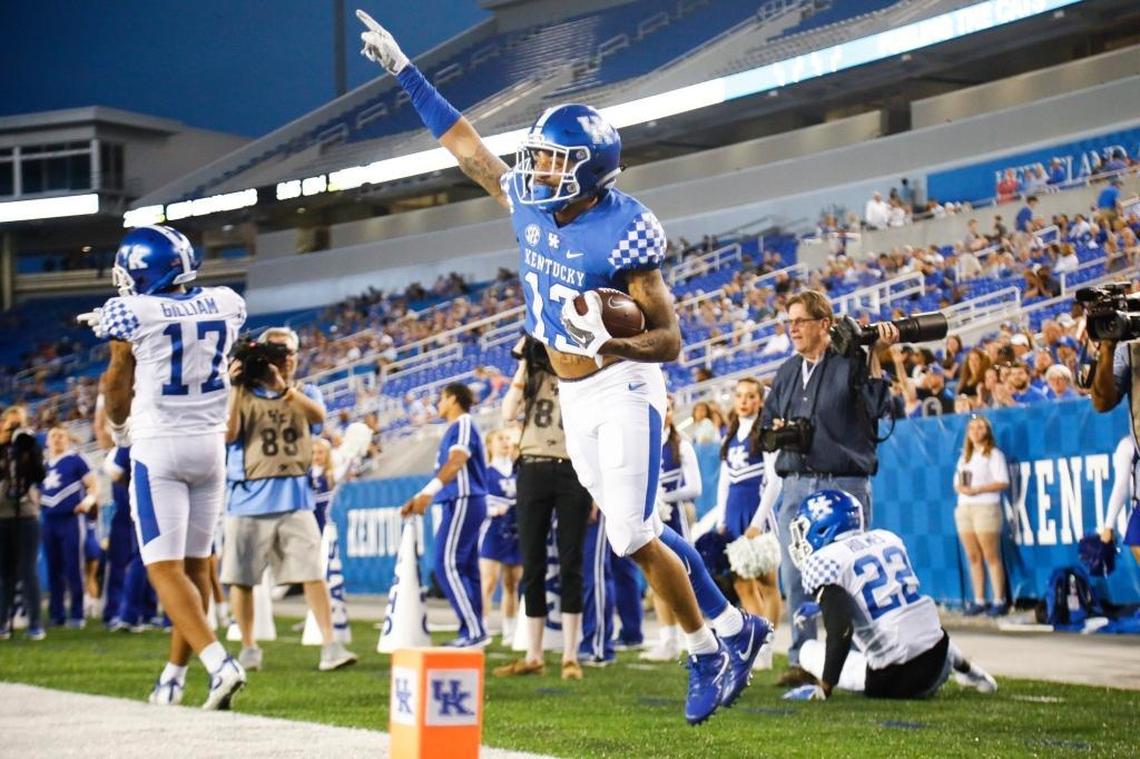 Former McCracken County star Zy’Aire Hughes (13) celebrated after catching a 19-yard touchdown pass from Walker Wood in Kentucky’s 2018 Blue-White Spring Game. “Zy’Aire ... has some juice and he has some speed and he can get open,” Kentucky Coach Mark Stoops said.