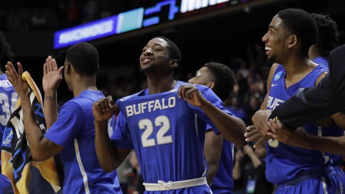 Buffalo guard Dontay Caruthers (22) celebrates on the bench after Buffalo upset Arizona 89-68 in a first-round game in the NCAA men's college basketball tournament Thursday, March 15, 2018, in Boise, Idaho.