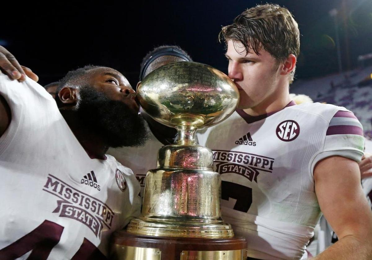 Mississippi State quarterback Nick Fitzgerald, No. 7, kissed the “Golden Trophy” as after leading the Bulldogs to a 55-20 win over archrival Mississippi in last season’s “Egg Bowl.”