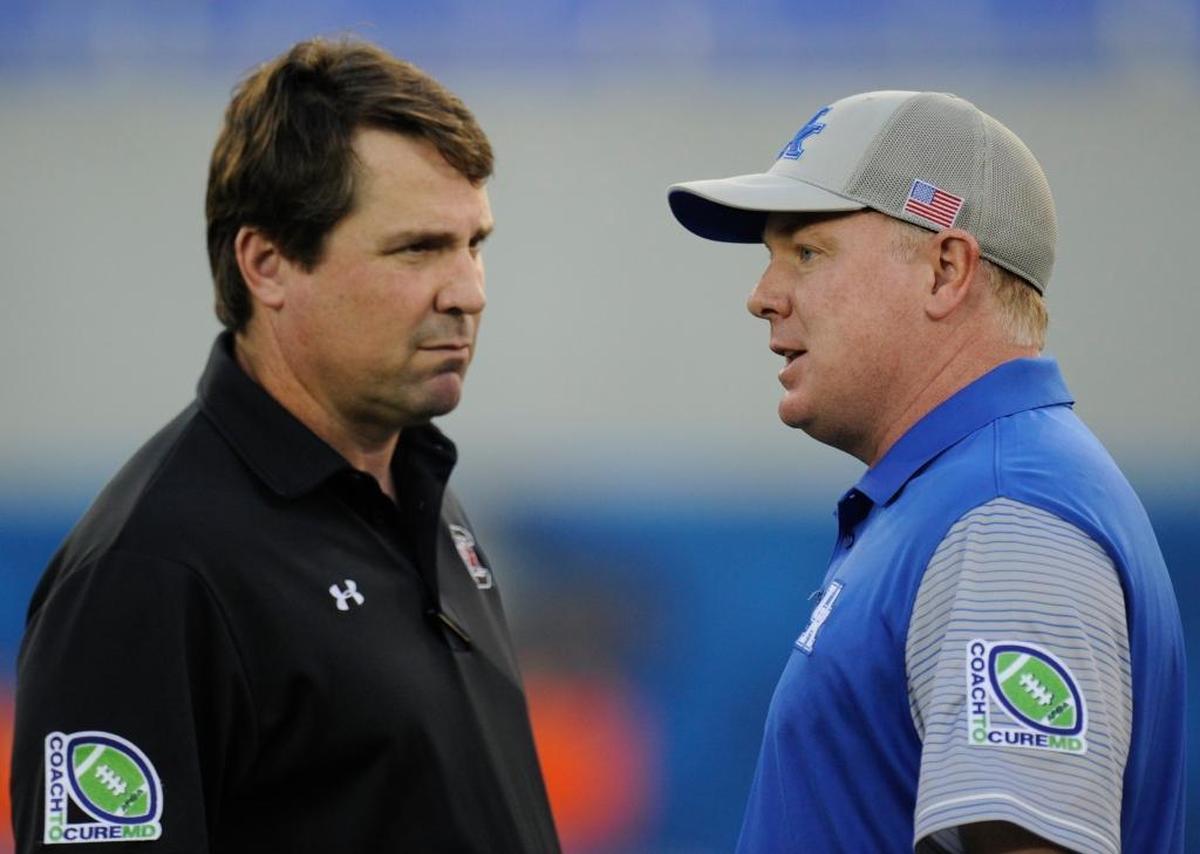 Kentucky Coach Mark Stoops, right, has beaten South Carolina four seasons in a row, the last two of those victories coming against Gamecocks teams coached by Will Muschamp, left.