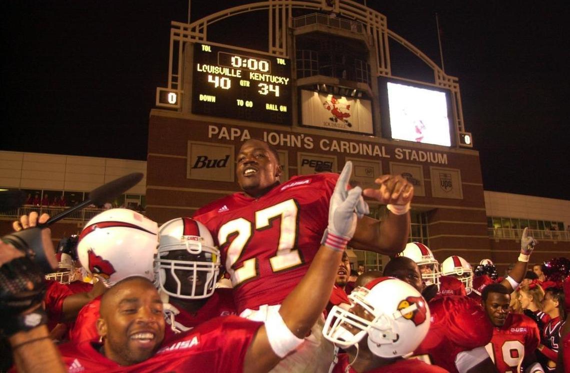 Louisville’s Tony Stallings is lifted on the shoulders of his teammates after scoring the game-winning touchdown in overtime to give the Cardinals a 40-34 victory over Kentucky in 2000.