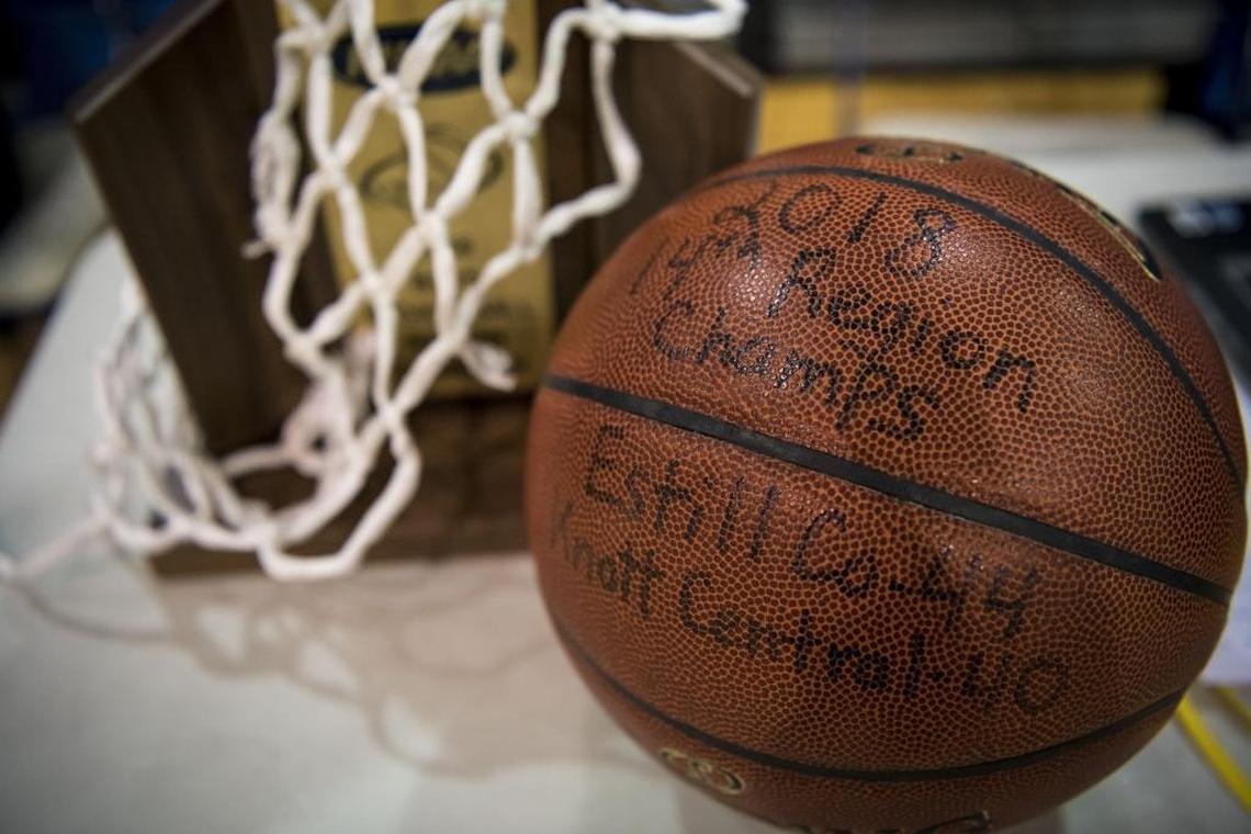 After winning the 14th Region for the first time, the Estill County basketball team kept the game ball and trophy close by during practice last Friday.
